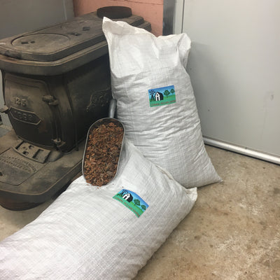 Bag of pecan shell mulch with scoop full of pecan mulch